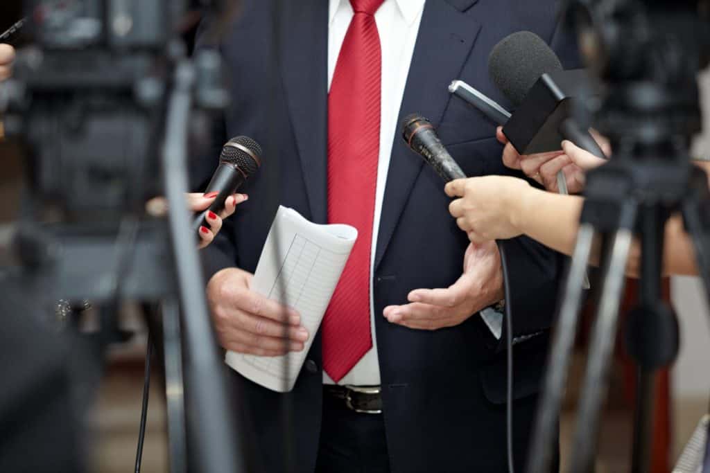 close up of conference meeting microphones and businessman