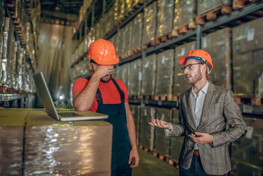 Not satisfied. Manager talking to the warehouse worker and critisizing his work