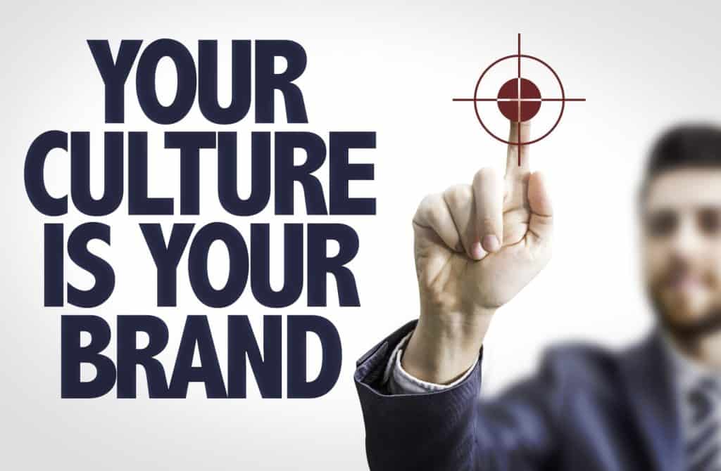 Business man pointing the text: Your Culture is Your Brand
